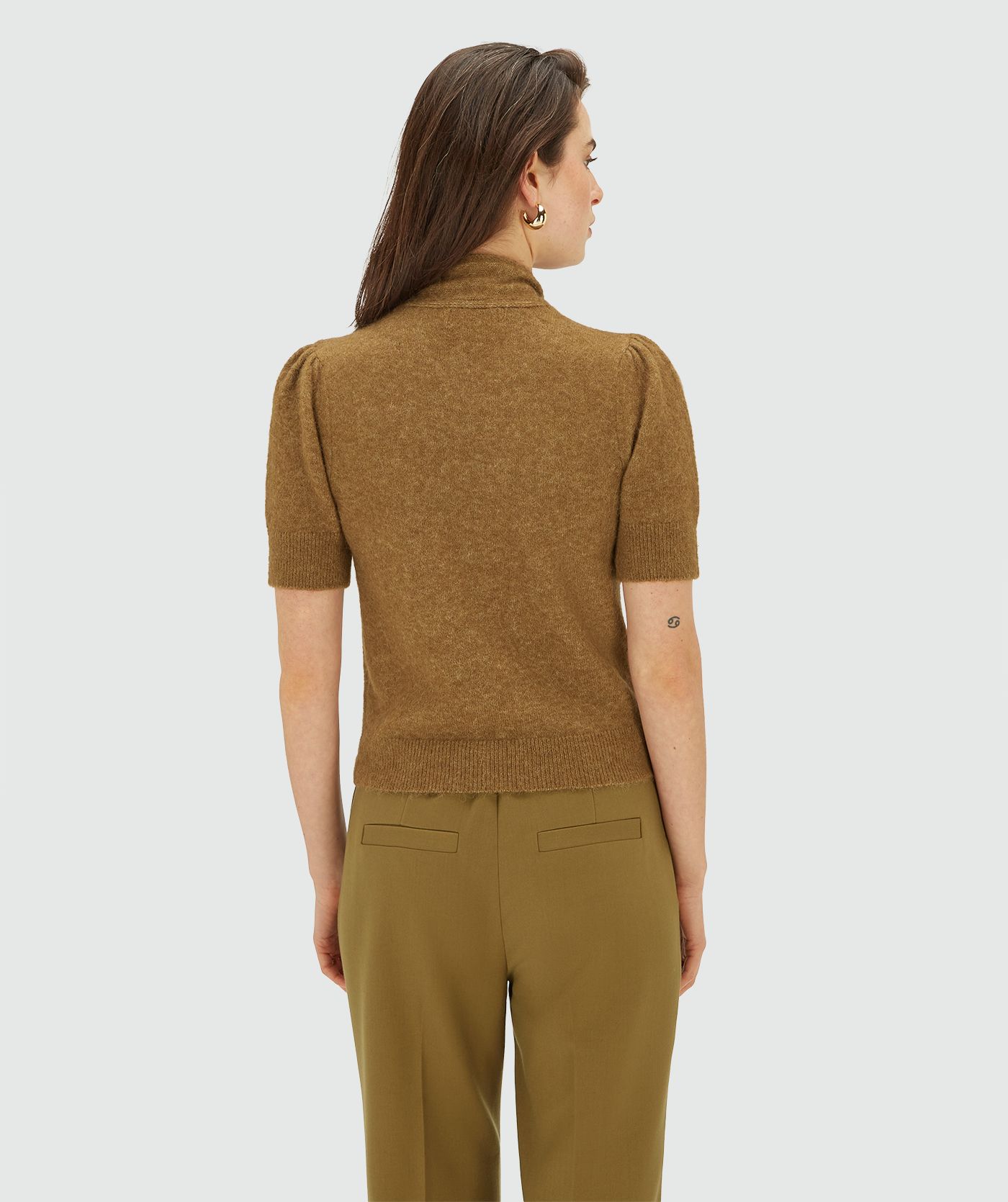 Achteraanzicht van model in een Olive Green Melange knit top met korte mouwen en strikdetail bij de hals