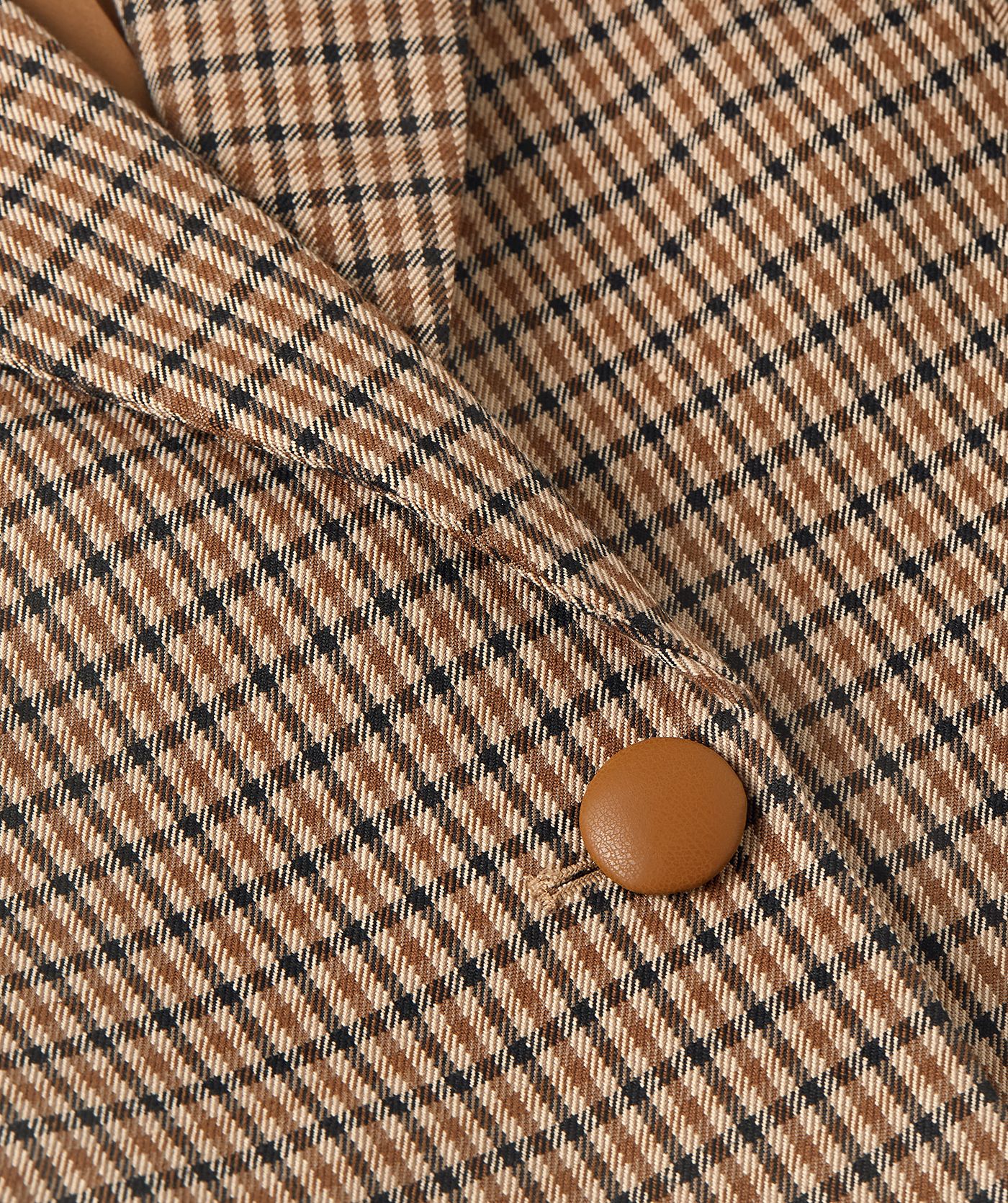 Close-up van een getailleerde blazer met ruitjes