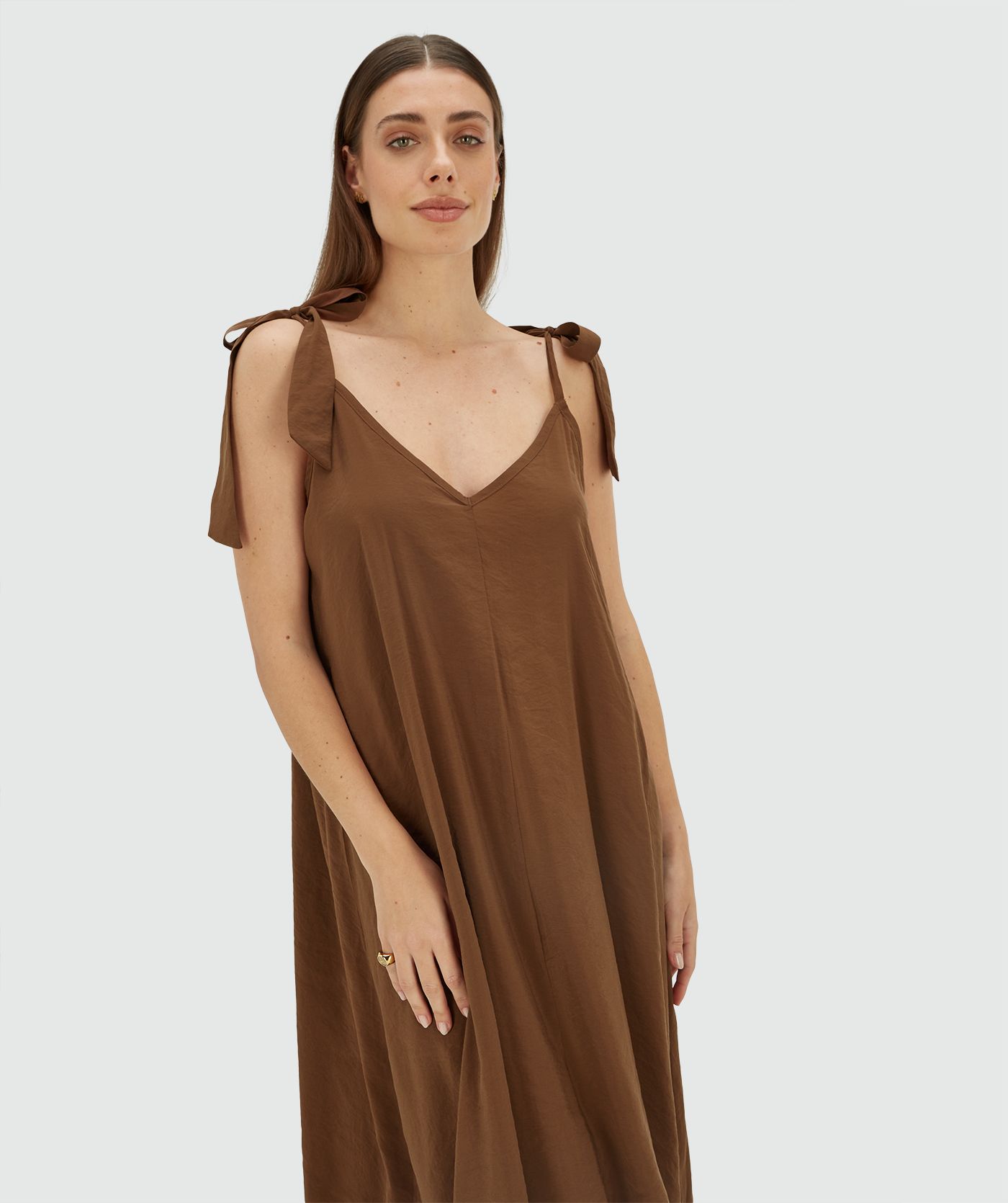 Model draagt een maxi jurk met striksluiting in de kleur Brown