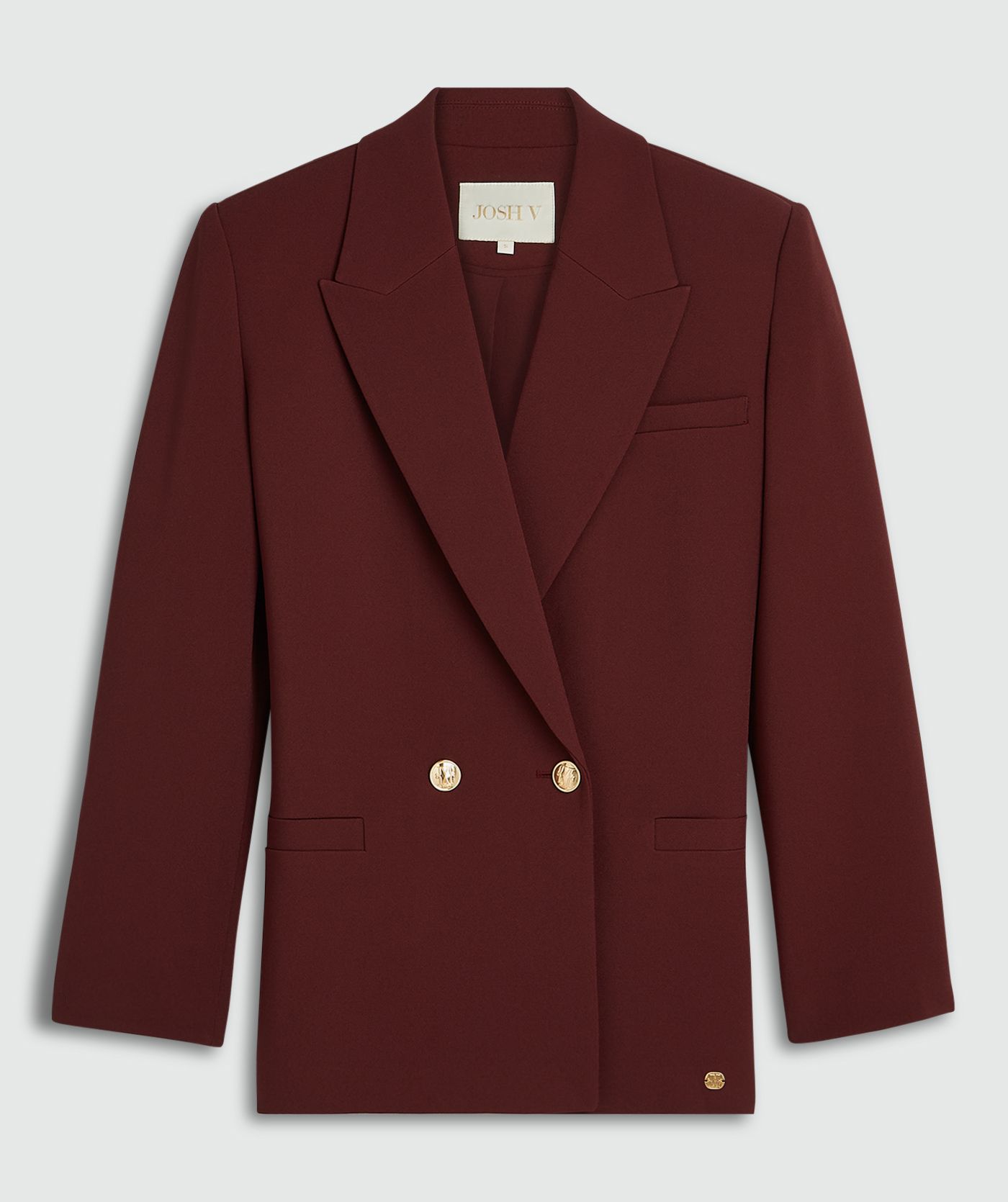 Donkerrode blazer met gouden knopen zonder model, weergegeven op een lichtgrijze achtergrond.