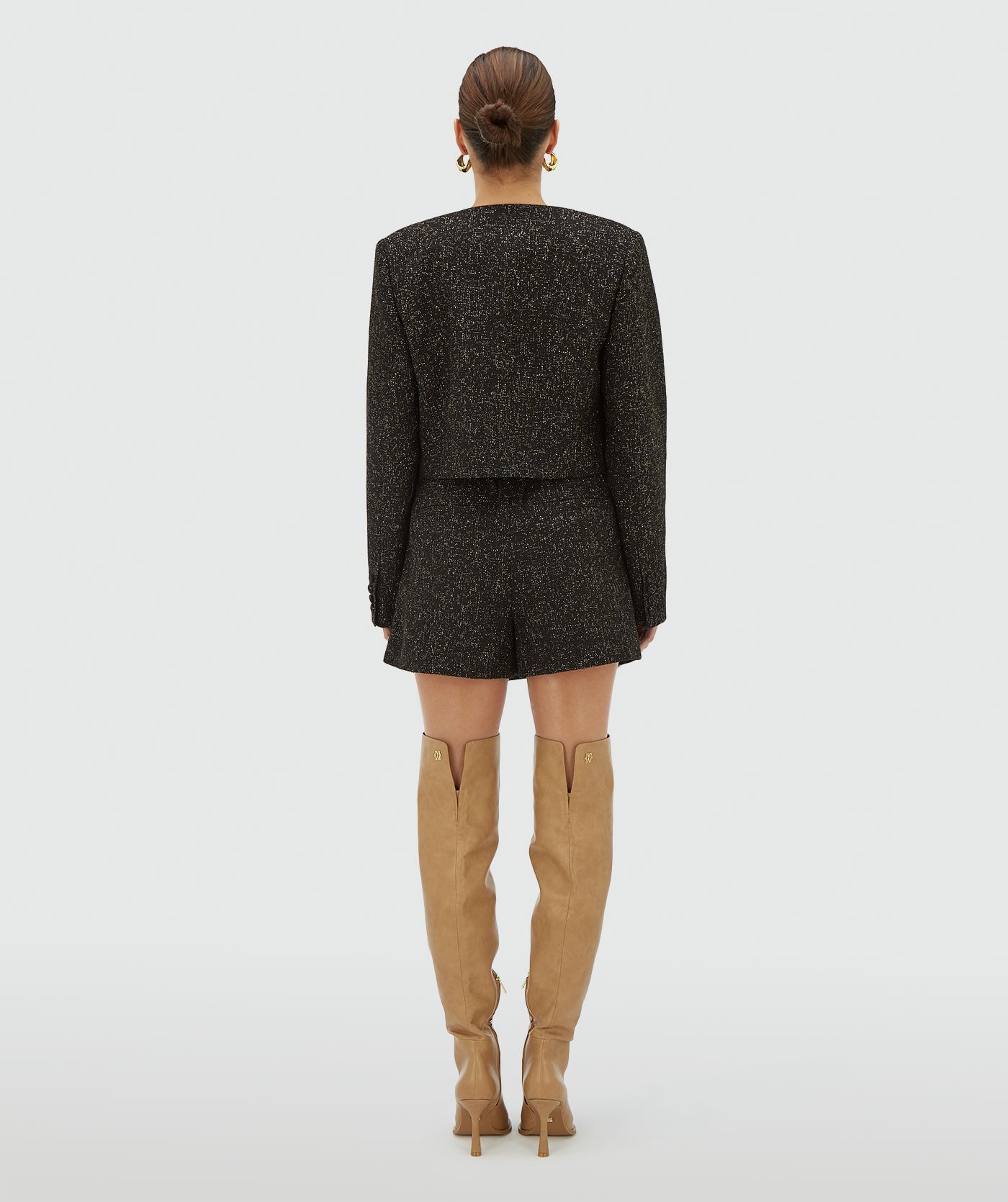 Achteraanzicht van een zwarte skort met goud- en zilverkleurig luxedraad - JOSH V