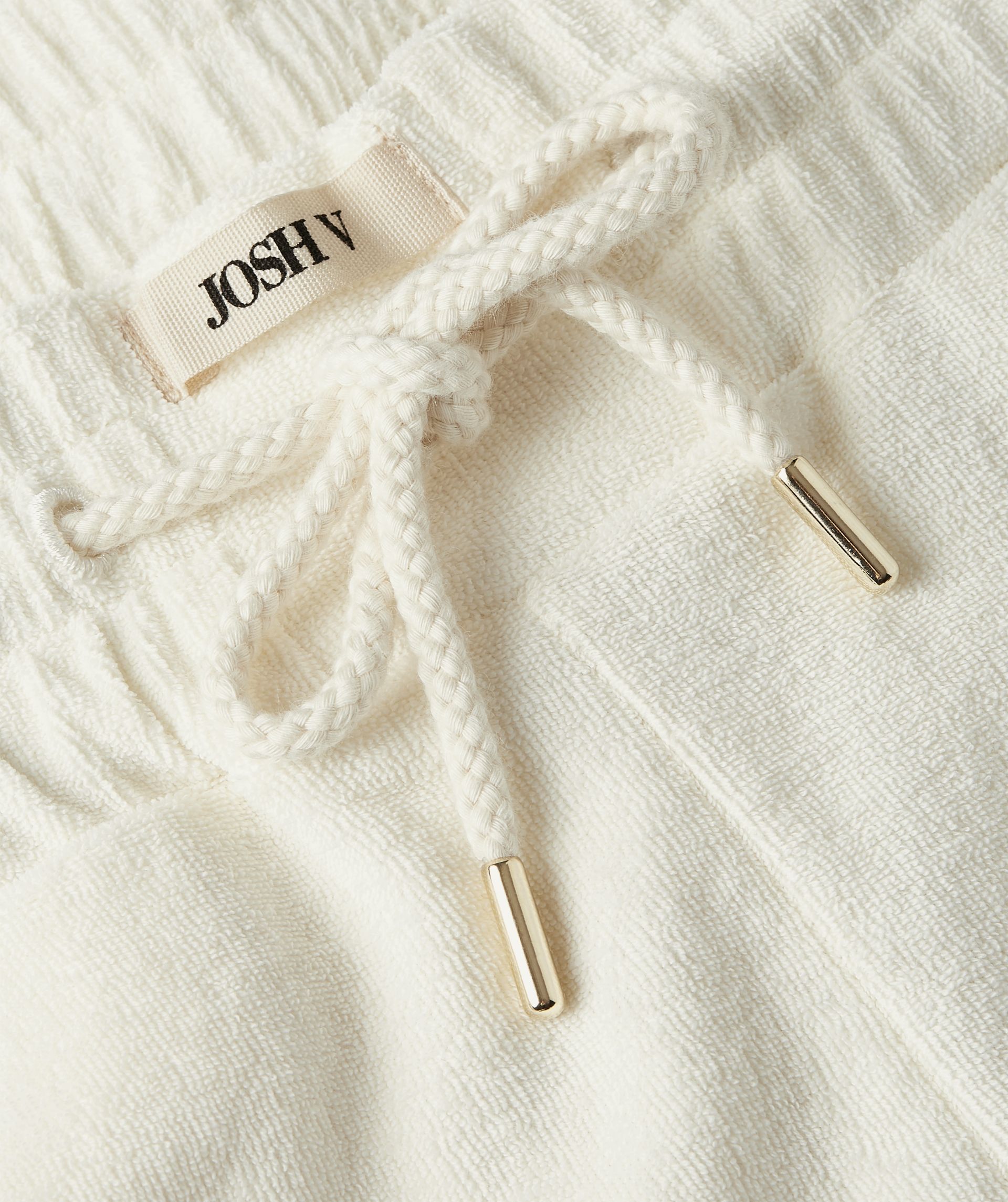Close-up van gebroken witte katoenen badstof - Josh V.