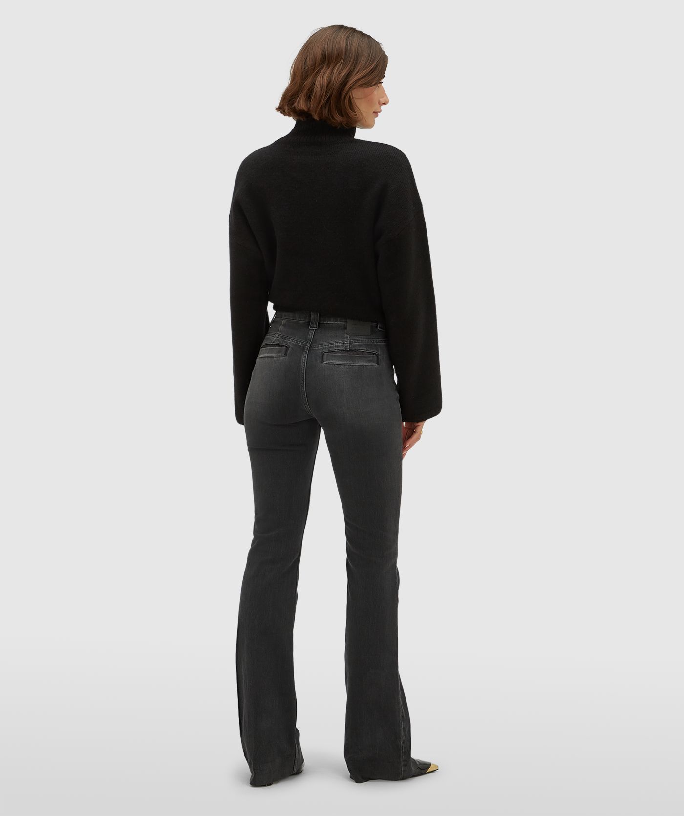 Achteraanzicht van een model in een mid rise flared jeans