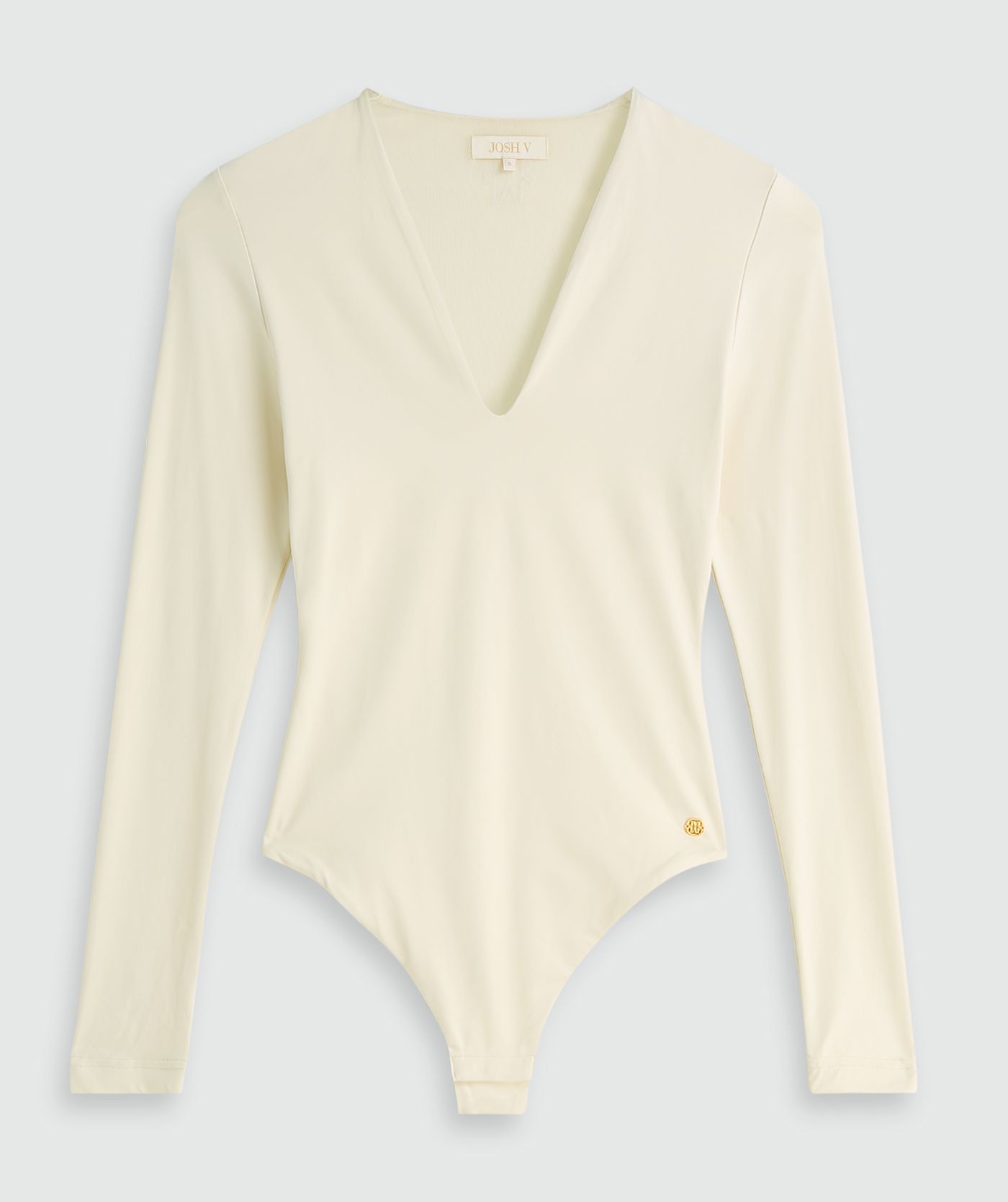 Crème body met lange mouwen zonder model, weergegeven op een lichtgrijze achtergrond